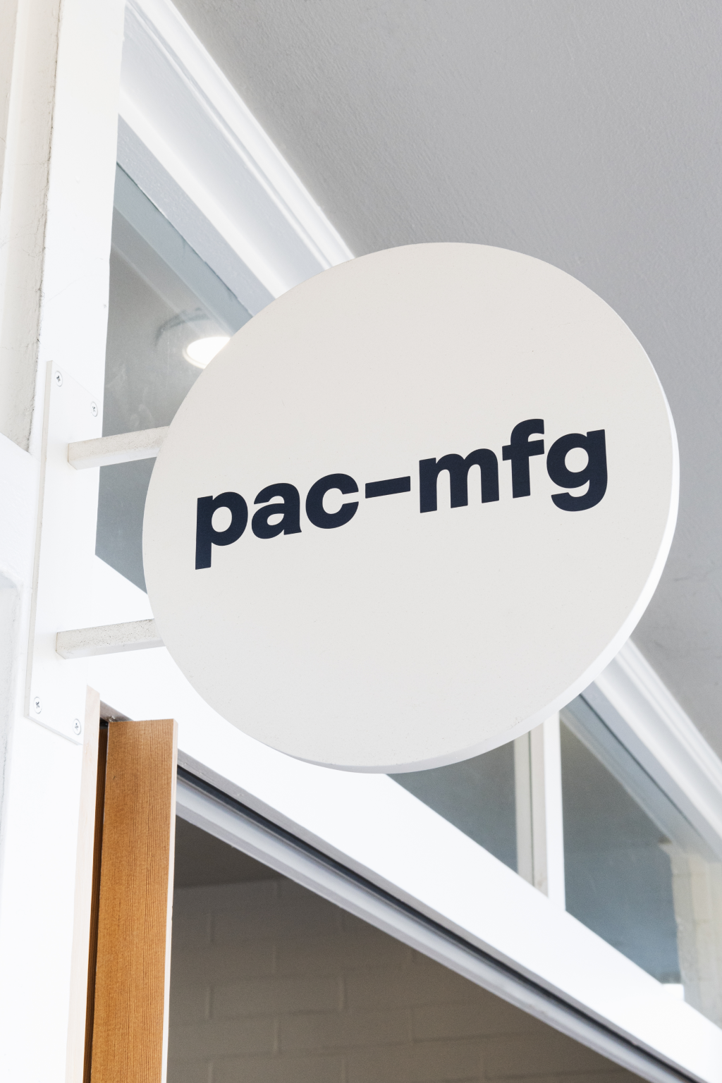 PM (PAC-MFG) branded sign outside of store in Birdrock, La Jolla, California, featuring the company name.