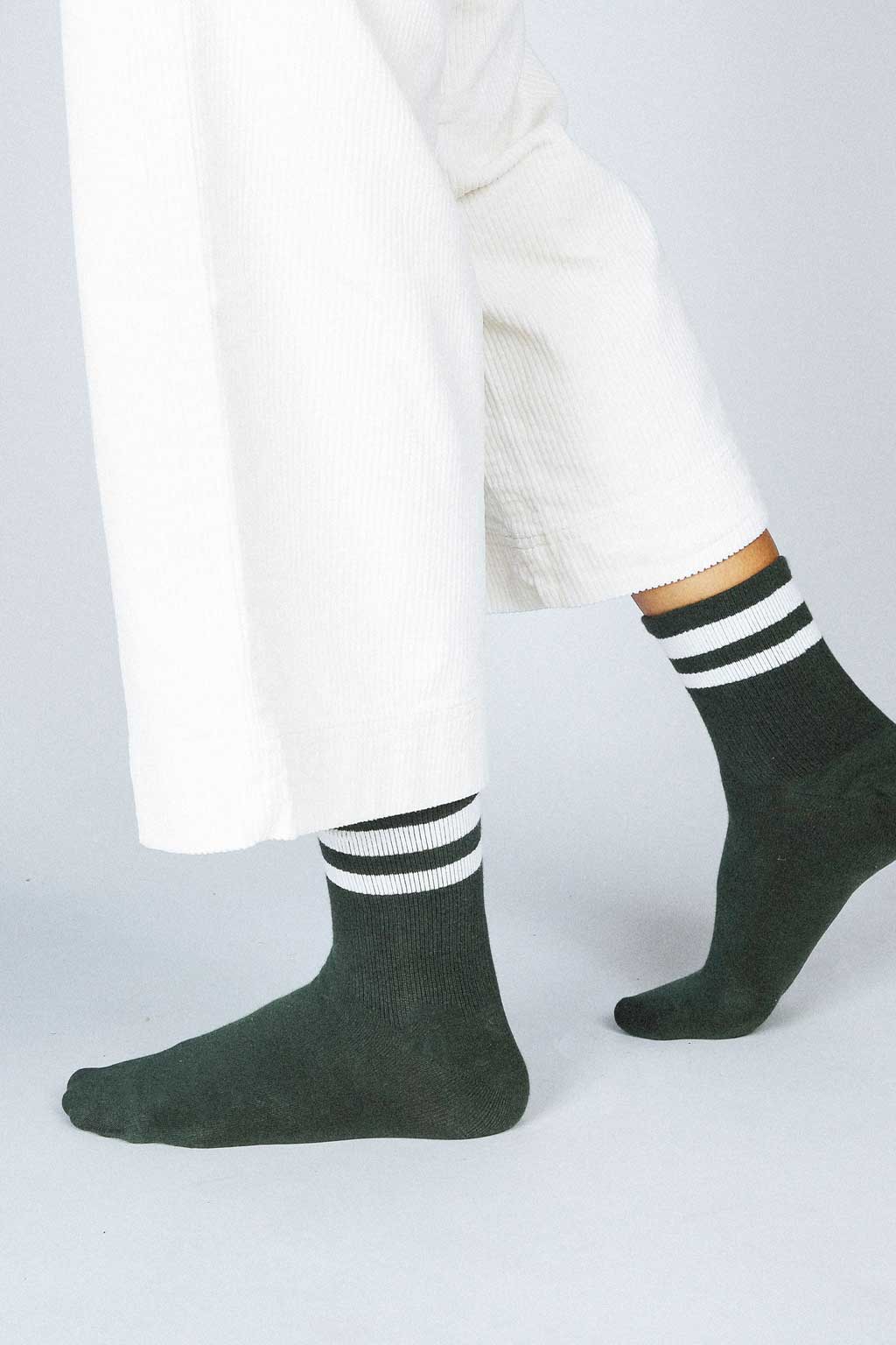 Close up photo of woman's feet wearing Tailored Union baseball ankle socks 